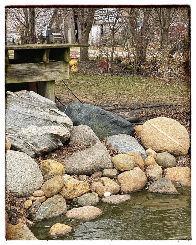 Duck egg at the outside edge of dick pond. Pond surrounded in large river rocks.