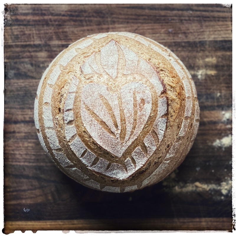 Red Fife loaf of bread with heart scoring. Flour from Janie's Mill.