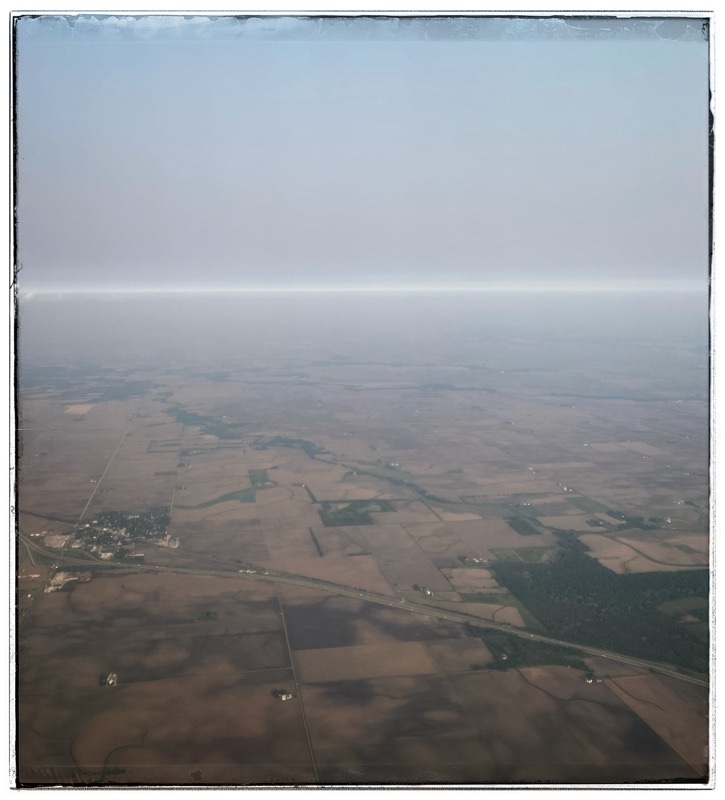 hazy light across a rural flat rural landscape taken from a plane