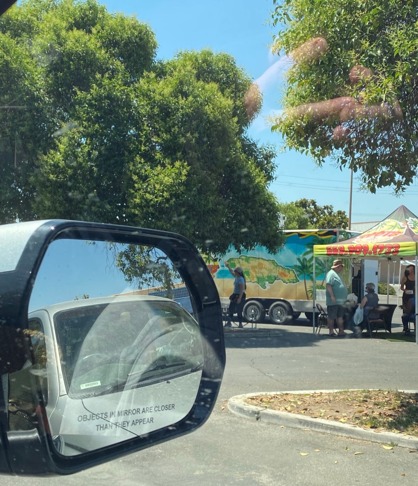 looking out a car window at the farmers market