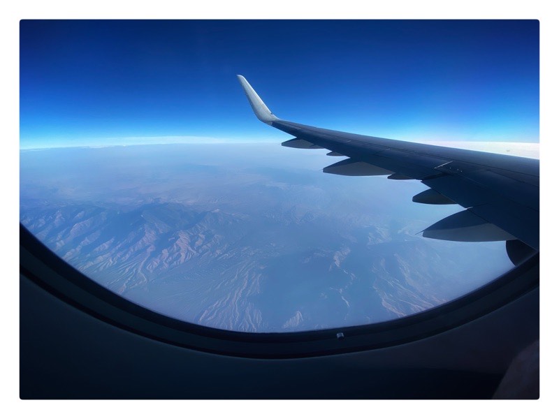looking out a plane window, hills and mountainous view