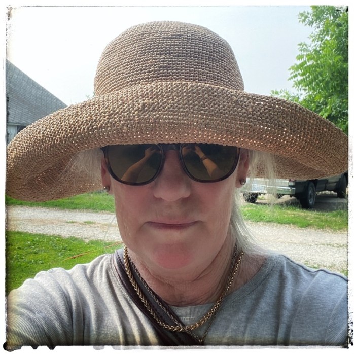 white woman wearing sunhat