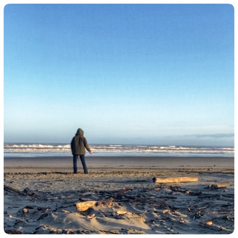 woman on the winter beach in coat. 