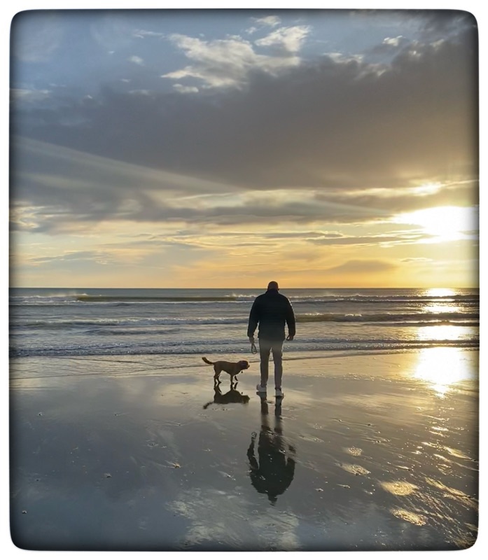 man and dog on beach