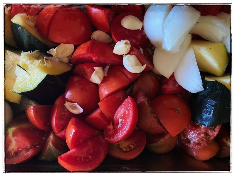 tomatoes oninos and garlic chopped and ready to roast. 
