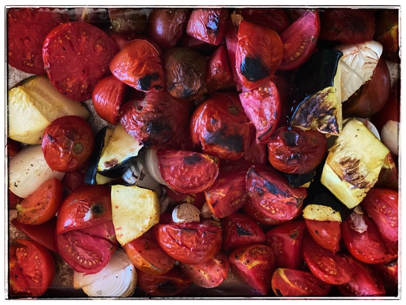 charred tomato and onion ready for tomato conserva, garlic