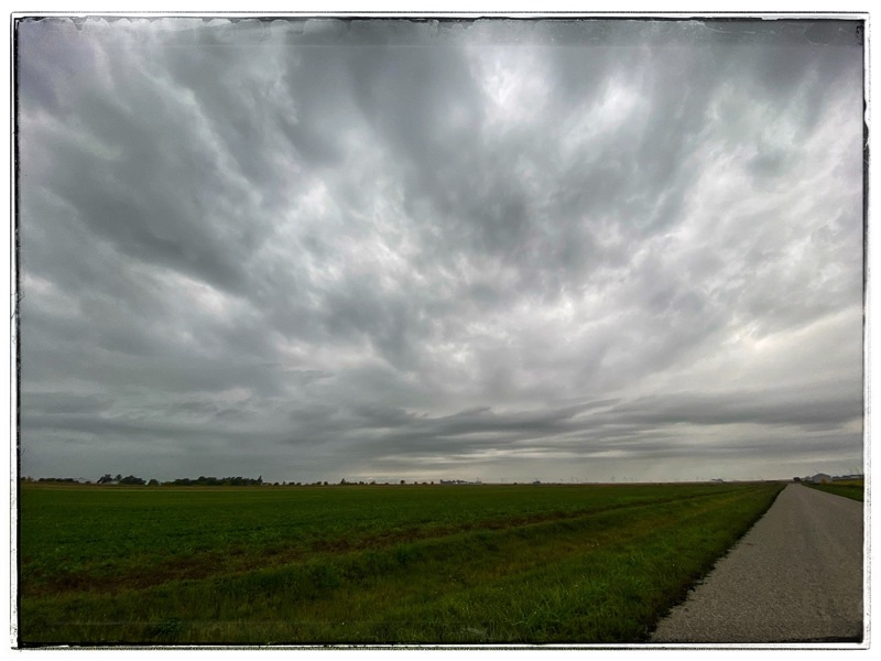 view of the rain clouds across the fields.