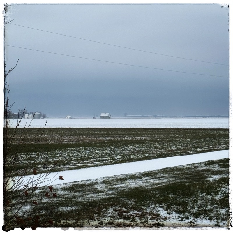 Dark snowfield clouds above Prairie Fields flat landscape